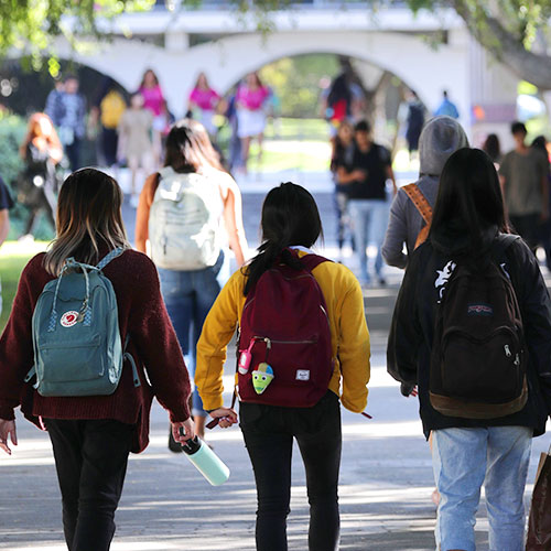 UCR students walking on campus near Watkins Hall.